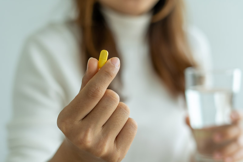 Woman Holding Eye Vitamin