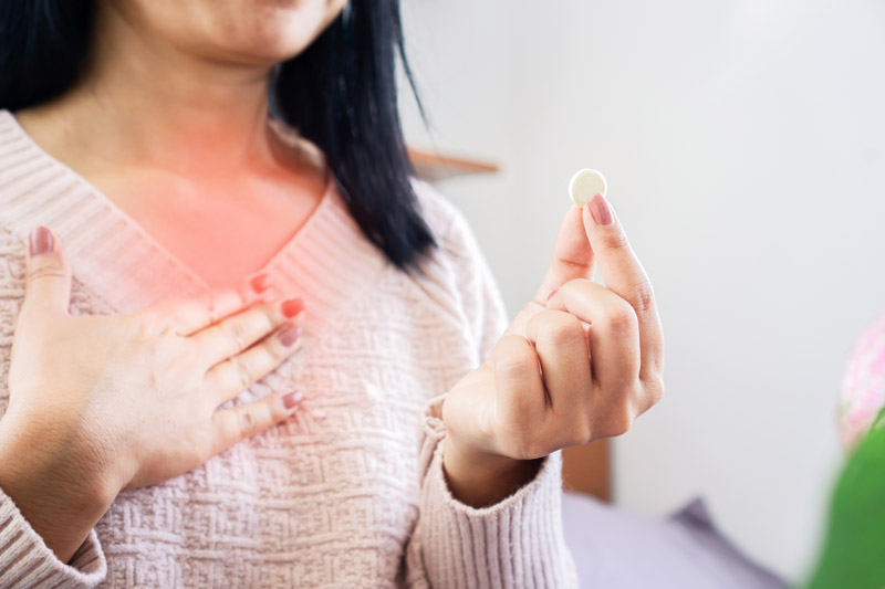 Woman with Supplement for Indigestion